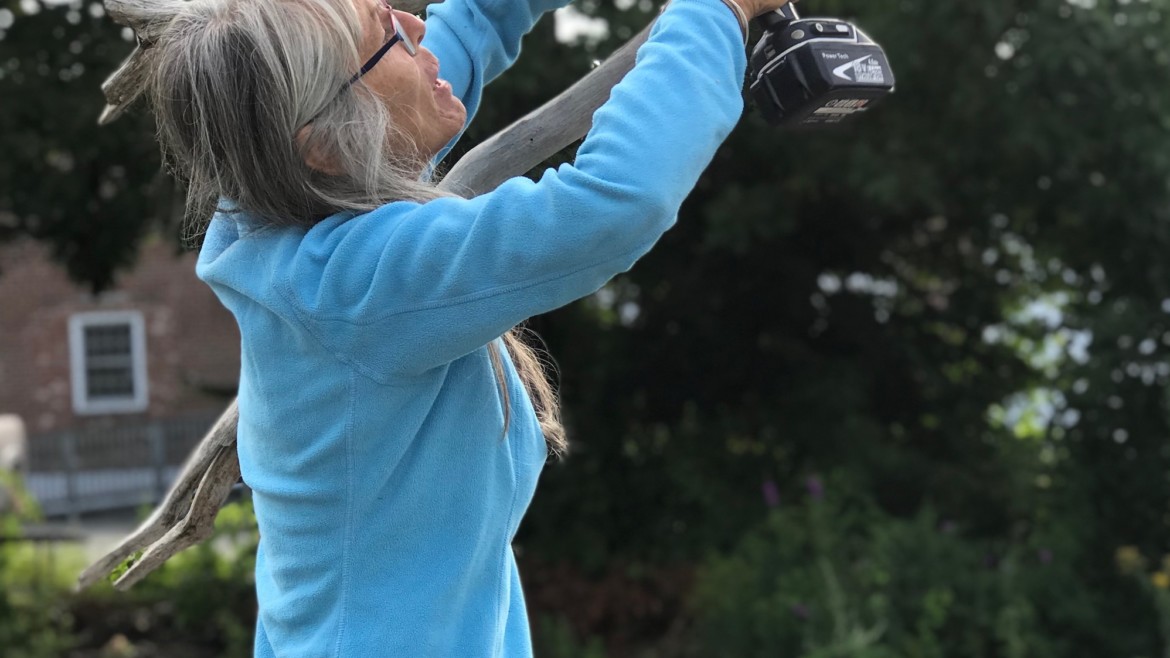Cherie Herne building a driftwood arch